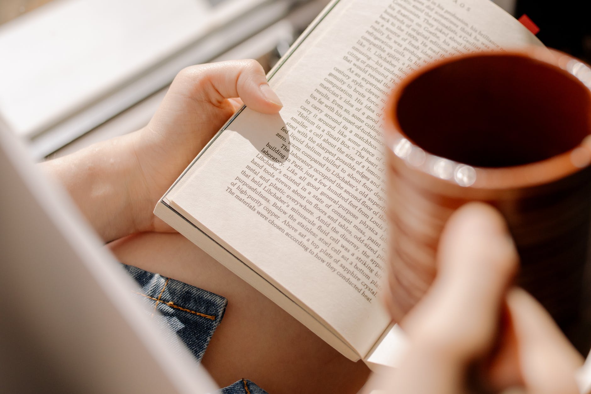 person holding white paper cup